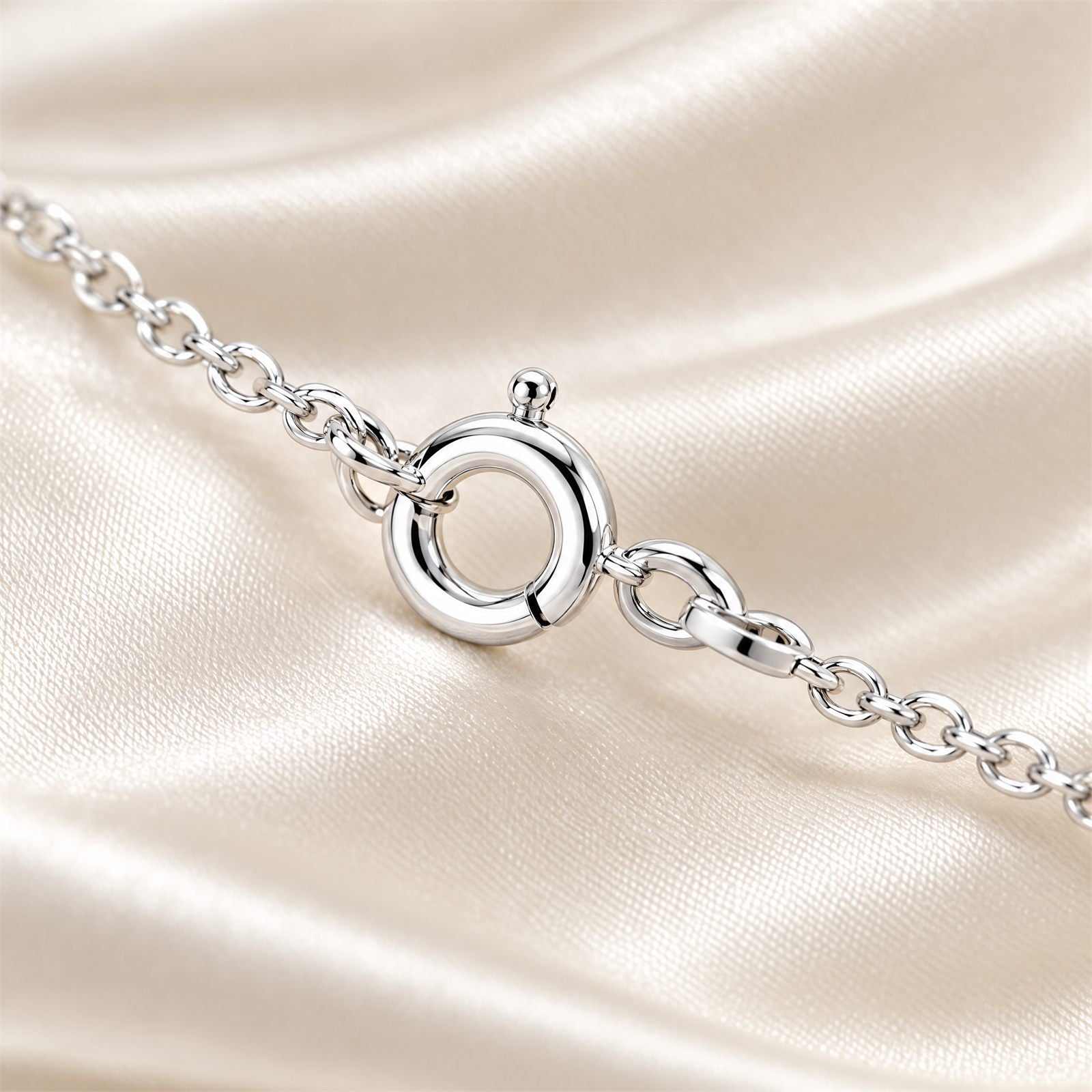 The spring-ring clasp resting on ivory satin